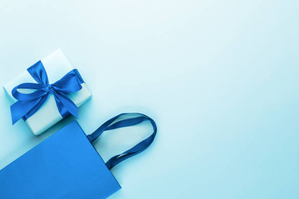 istock Blue gift box with blue ribbon and bow and blue craft bag.Greeting card. 2201479726