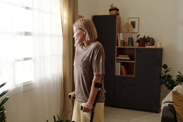 istock Elderly Woman Looking Out Window with Calm Expression 2201479744