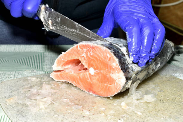 istock The cook prepares the fish for cooking 2201479998