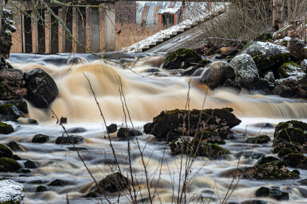 istock winter landscape with rapid river flow, blurred water surface, blurred movement, rapid stream of wild river 2201481340