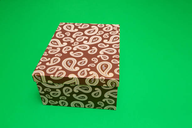 Closed cardboard gift box with paisley pattern on a chroma key background, ready for your design or text