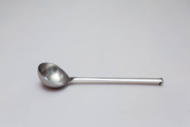 istock Stainless steel ladle lying on white background 2201484711