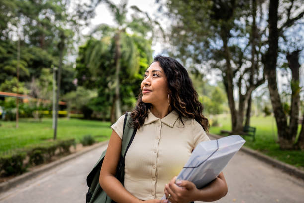 Young woman student contemplating in a public park