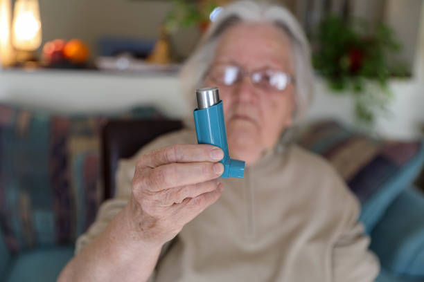 istock Close-Up of an Elderly Woman Using an Asthma Pump 2201487078
