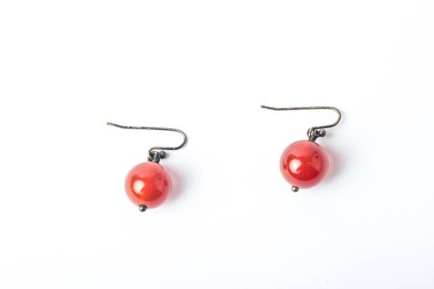 A pair of simple earrings with red round beads
