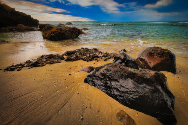 View from the beach to the sea with a rock in the foreground