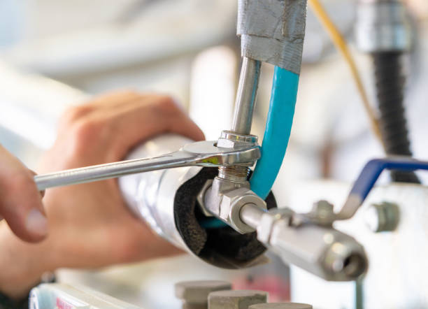 istock Hands using a wrench to tighten connections on an insulated pipeline system. 2201495338
