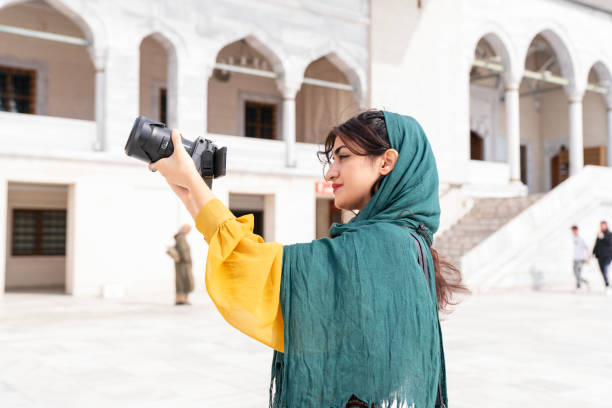istock Young Muslim woman taking photos while traveling 2201496620