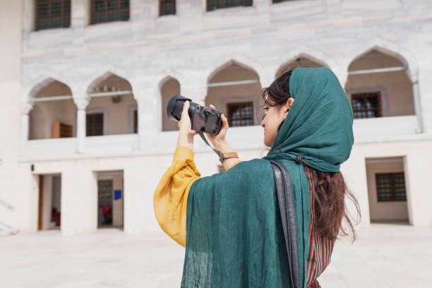 istock Young Muslim woman taking photos while traveling 2201496642