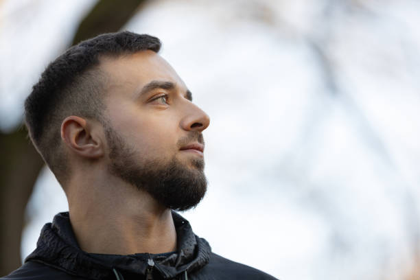istock A young man looking at the nature around him and smiling 2201497876