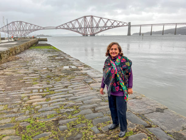 istock Senior Hispanic woman portrait at Forth Bridge Scotland 2201499931
