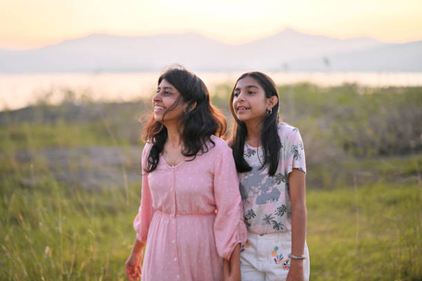 istock Mother and daughter enjoying the sunset while having a stroll in nature 2201506617