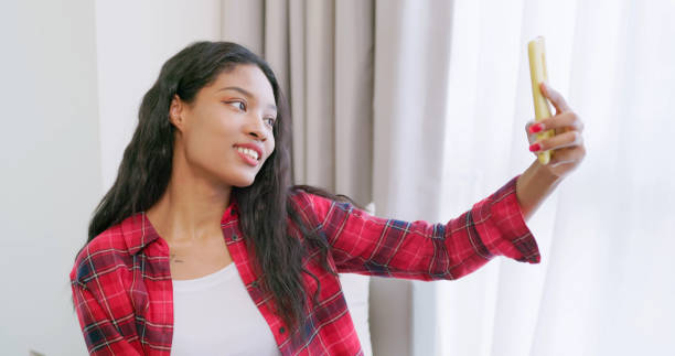 istock ebony woman is taking selfie 2201507588