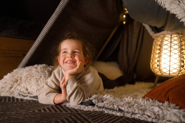 istock Happy Little Girl Playing Inside a Cozy Blanket Fort 2201508471