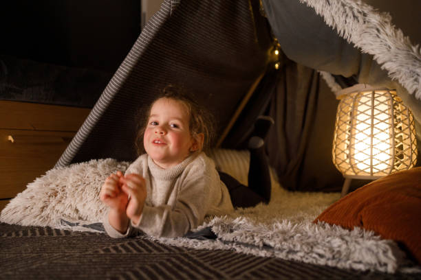istock Happy Little Girl Playing Inside a Cozy Blanket Fort 2201508482