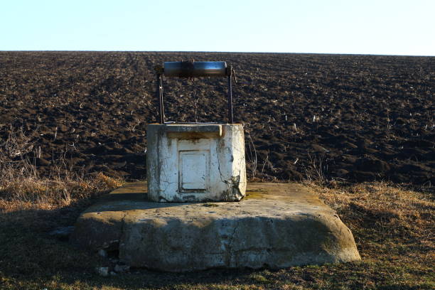 A large rock with a metal cylinder on top