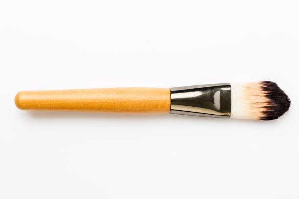 A blush applicator with a wooden handle and black bristles