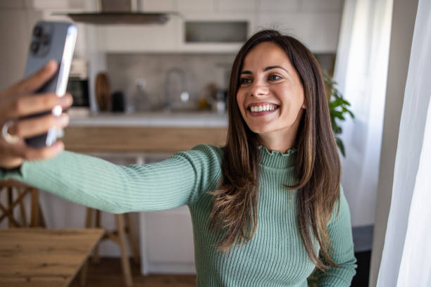 istock Young woman taking a selfie with a smile 2201514583