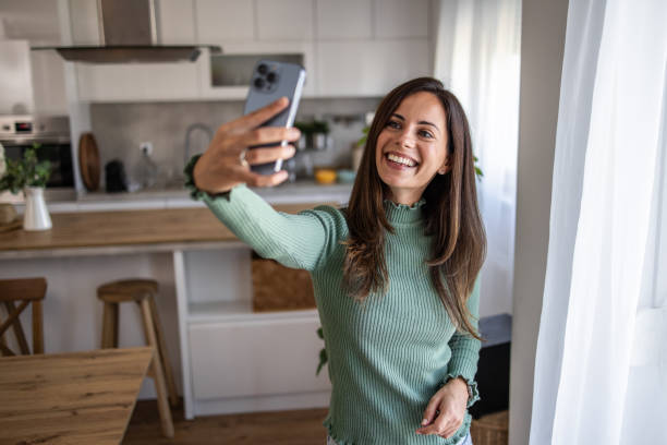 istock Young woman taking a selfie with a smile 2201514584