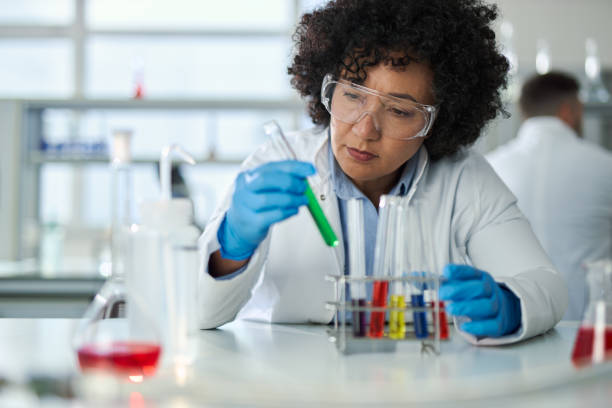 istock Mid adult scientist examining chemical substance in a beaker while working on an experiment. 2201516968