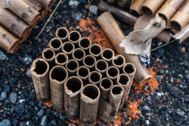 istock Burnt-Out Fireworks Casings on Asphalt After Celebration 2201517125