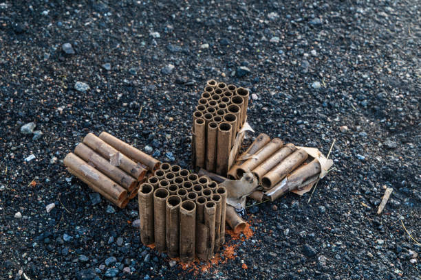 istock Burnt-Out Fireworks Casings on Asphalt After Celebration 2201517226