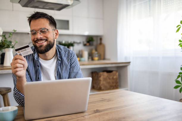istock Man browsing online stores and shopping at home 2201517969