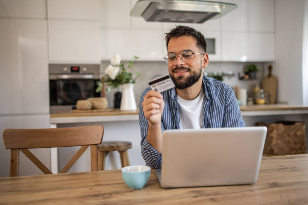 istock Man browsing online stores and shopping at home 2201517974