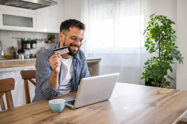 Man browsing online stores and shopping at home