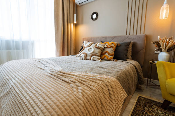 istock This cozy bedroom includes a comfy bed for restful sleep, a chic reading chair for relaxation, a practical work table for productivity, and a bright window for delightful natural light 2201519147