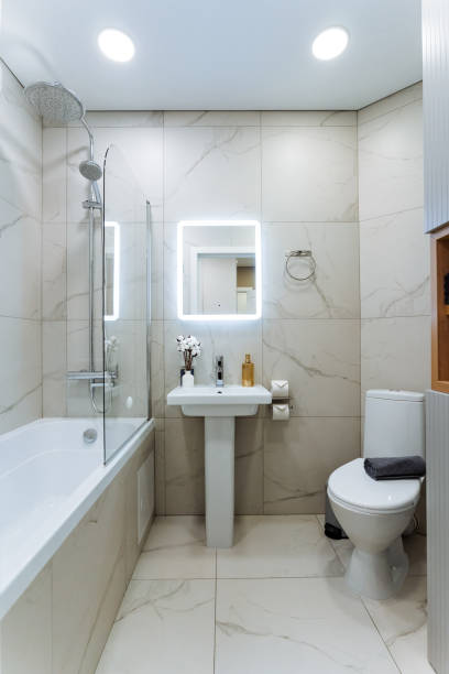 istock Imagine a bathroom that is equipped with essential amenities including a sink, a toilet, a bathtub, and a mirror, creating a fully functional and comfortable space for daily routines 2201519149