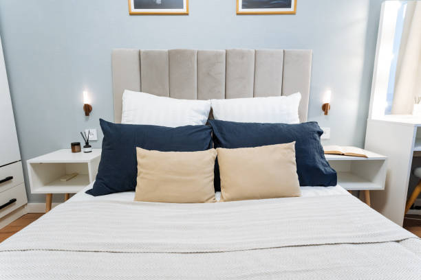 istock A cozy bedroom features a beautifully designed bed with an elegant headboard and soft pillows, creating a warm, relaxing atmosphere that enhances the spaces overall beauty 2201519163