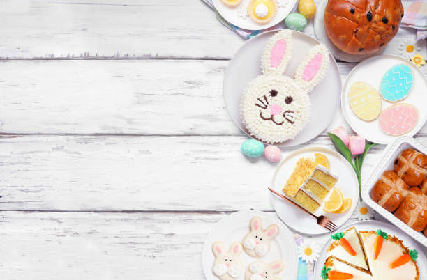 istock Easter or spring dessert food side border. Overhead view over a white wood background. 2201520921
