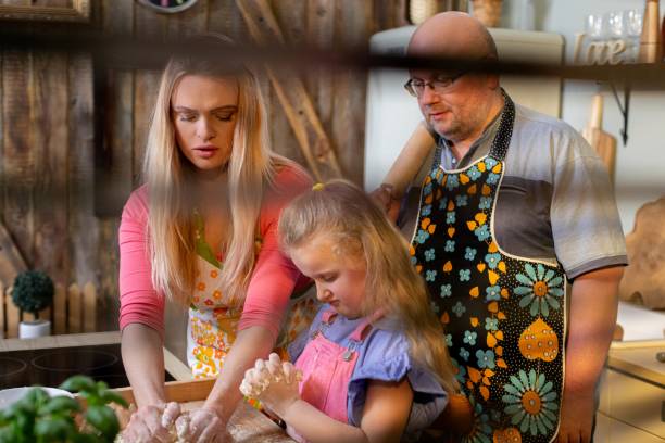 Family preparing dough making homemade bread.Union and joy in the kitchen.