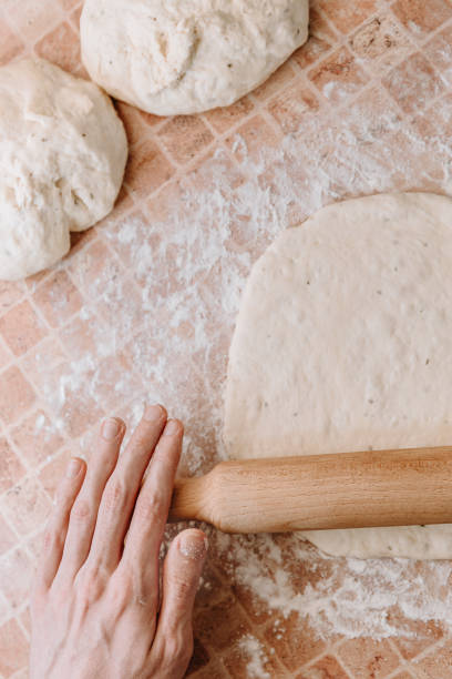 istock Rolling Fresh Dough For Homemade Bread Or Pizza 2201524356
