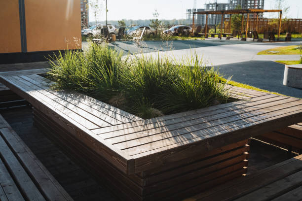 istock A wooden bench with a planter in the middle of it 2201525580