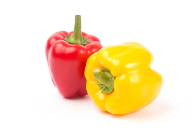 Red and yellow bell peppers isolated on white background