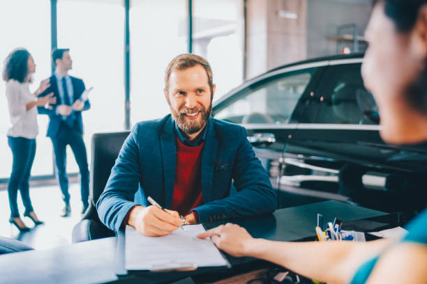 istock Businessman buying luxury car 2201526783