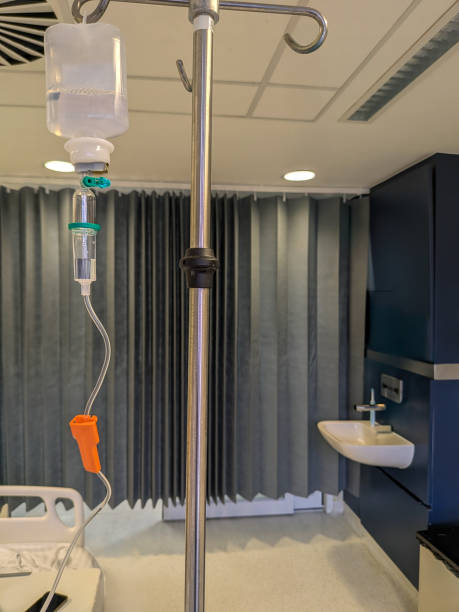 istock IV bag suspended from a stand in a medical setting during a treatment session 2201527189