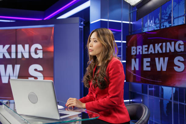 istock Female breaking news anchor 2201528800