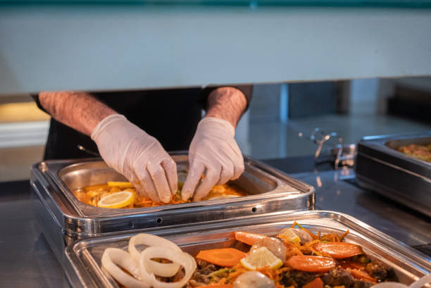 istock Restaurant service staff complete the meals at the hotel buffet. 2201529104