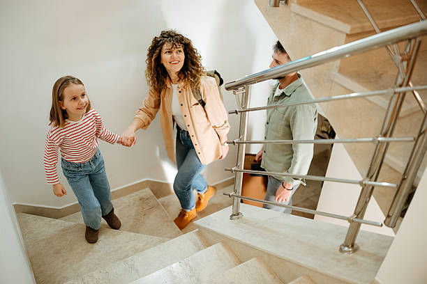 A family climbs the stairs to an apartment.