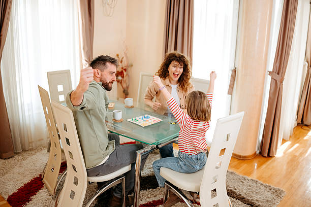 istock Family with child having fun playing board games 2201529603