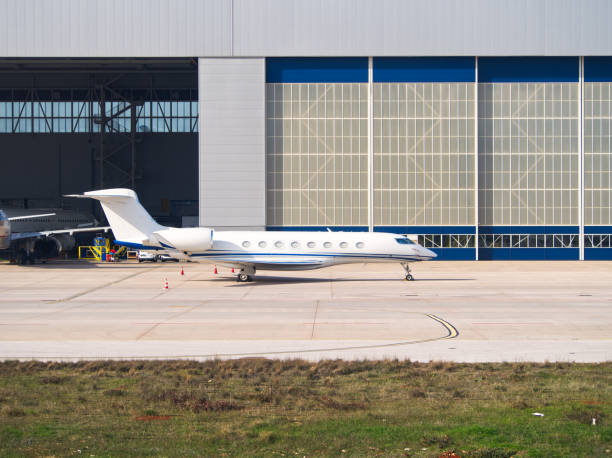 istock Private jet parked outside aircraft hangar 2201529628