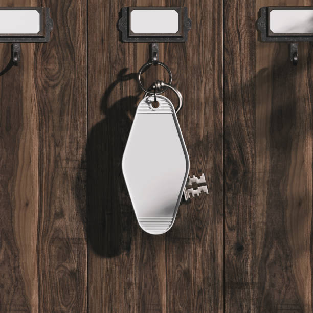 Blank hotel key ring is hanging on the key rack mockup. 3D rendering