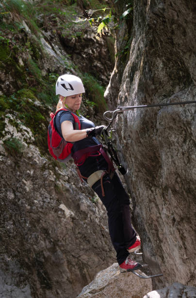 istock A female climber on a via ferrata climbs a rocky outcrop 2201533836
