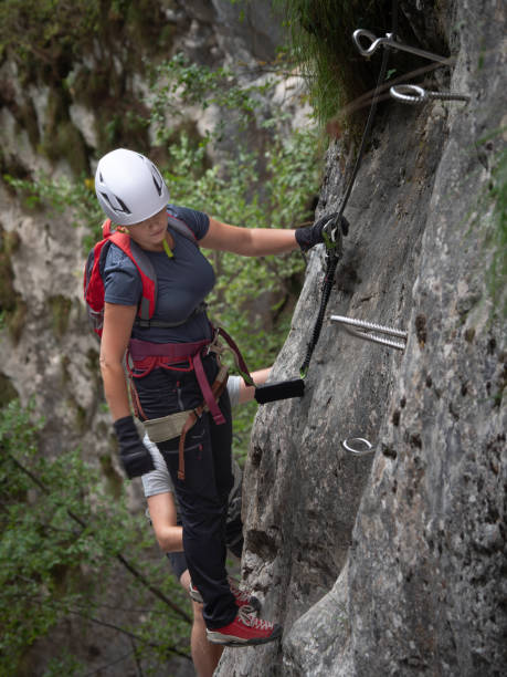 istock Female climber chooses a path to go on a via ferrata. 2201533847