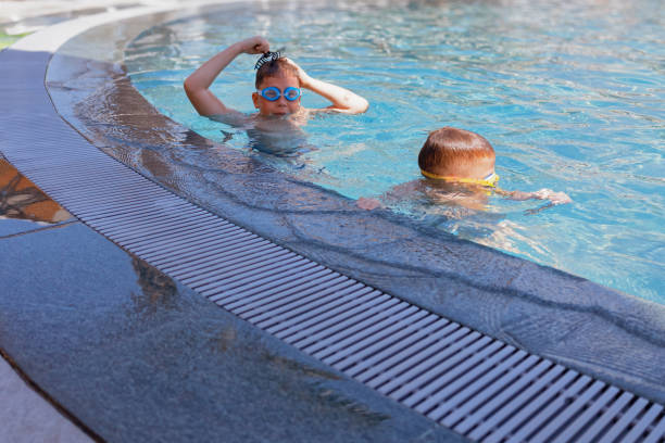 istock The brothers are having fun in the pool 2201534104