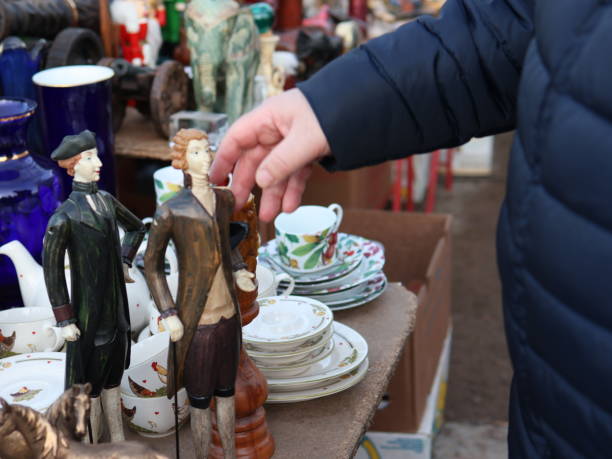 istock man looking at decorative figurines at a garage sale 2201534456