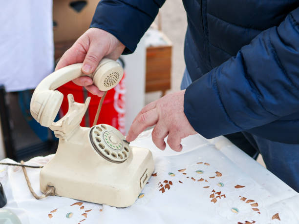 old white disk phone at a street sale